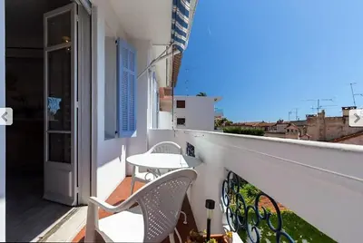 a balcony with a table and chairs on a building at Villa Lerina in Cannes