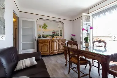 a living room with a table and a mirror at Villa Lerina in Cannes