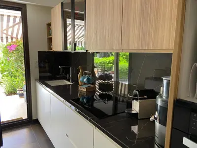 a kitchen with a black counter top and cabinets at Un Coin de Paradis in Cannes