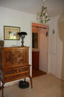 a room with a wooden dresser and a mirror at Un Coin de Paradis in Cannes