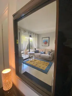 a view of a living room through a mirror at Un Coin de Paradis in Cannes