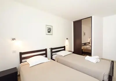 two beds in a room with a mirror at Viva Riviera 2 Bedrooms 2 Bathrooms Rue Florian in Cannes