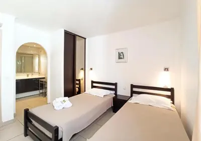 a hotel room with two beds and a bathroom at Viva Riviera 2 Bedrooms 2 Bathrooms Rue Florian in Cannes