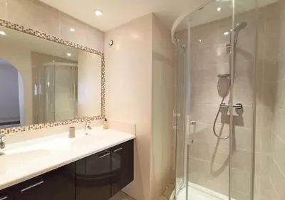a bathroom with a shower and a sink and a mirror at Viva Riviera 2 Bedrooms 2 Bathrooms Rue Florian in Cannes