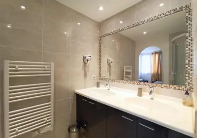 a bathroom with two sinks and a large mirror at Viva Riviera 2 Bedrooms 2 Bathrooms Rue Florian in Cannes