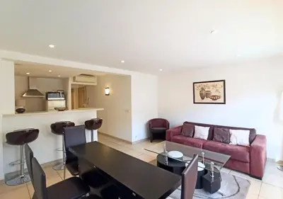 a living room with a table and a couch at Viva Riviera 2 Bedrooms 2 Bathrooms Rue Florian in Cannes