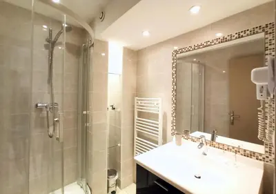 a bathroom with a shower and a sink and a mirror at Viva Riviera 2 Bedrooms 2 Bathrooms Rue Florian in Cannes