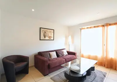 a living room with a couch and a glass table at Viva Riviera 2 Bedrooms 2 Bathrooms Rue Florian in Cannes