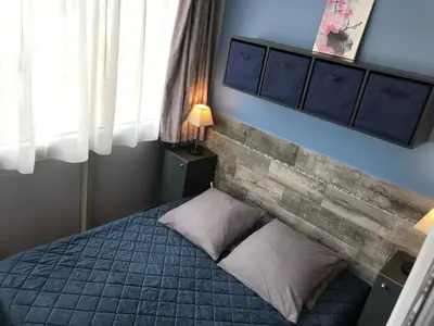 a bedroom with a bed and a brick wall at SOPHIES HOMES FÉLIBRIGES BEACH & PALAIS des FESTIVALS in Cannes