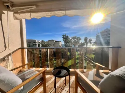 a room with a balcony with a view of the city at Studio Grand hôtel Croisette, by Welcome to Cannes in Cannes