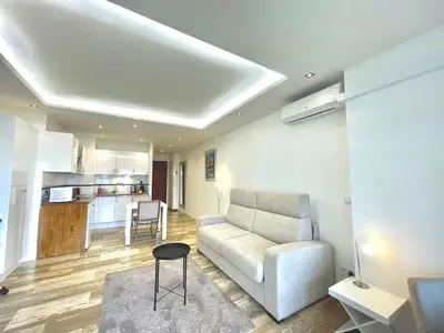 a living room with a couch and a table at Studio Grand hôtel Croisette, by Welcome to Cannes in Cannes