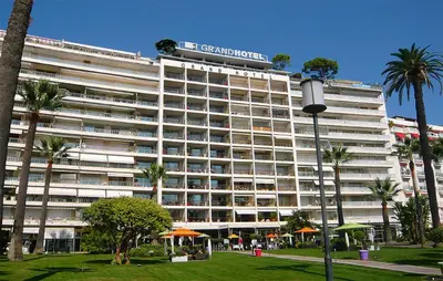 a large building with a sign on top of it at Studio Grand hôtel Croisette, by Welcome to Cannes in Cannes