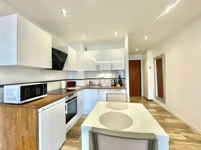 a kitchen with white cabinets and a counter top at Studio Grand hôtel Croisette, by Welcome to Cannes in Cannes