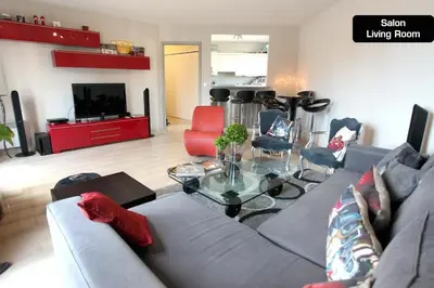 a living room with a couch and a table at Coeur de Cannes - 2 pièces moderne in Cannes