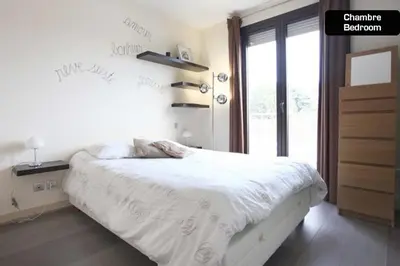 a bedroom with a white bed with a window at Coeur de Cannes - 2 pièces moderne in Cannes