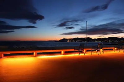 a group of chairs sitting on the beach at sunset at Coeur de Cannes - 2 pièces moderne in Cannes