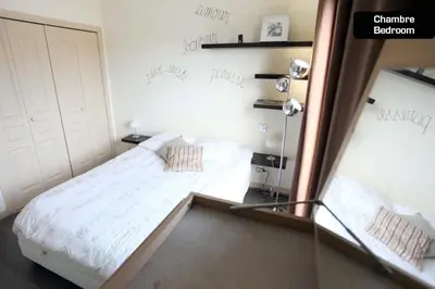a bedroom with a bed and a mirror at Coeur de Cannes - 2 pièces moderne in Cannes