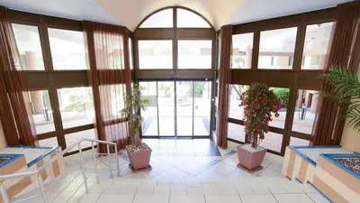 a lobby with two potted plants in a building at Cannes - view Cap Esterel in Cannes