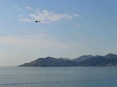 an airplane flying over a body of water at Cannes - view Cap Esterel in Cannes