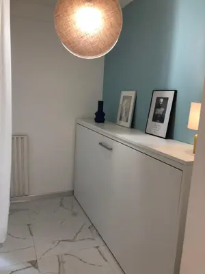 a room with a white refrigerator and a light at Majestic Apartment in Cannes