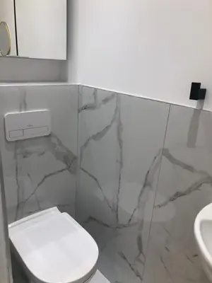 a bathroom with a white toilet and a sink at Majestic Apartment in Cannes