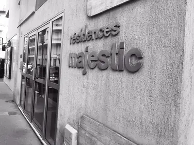 a store sign on the side of a building at Majestic Apartment in Cannes