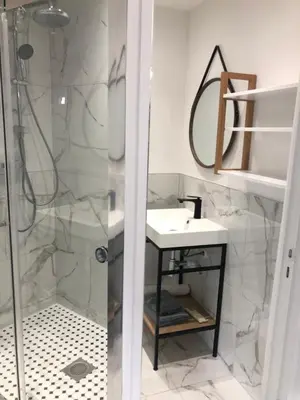 a bathroom with a sink and a shower at Majestic Apartment in Cannes