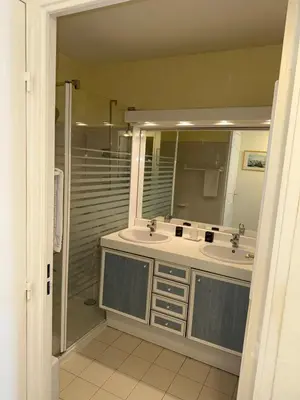 a bathroom with two sinks and a shower and a mirror at Villa Rimbaud in Cannes
