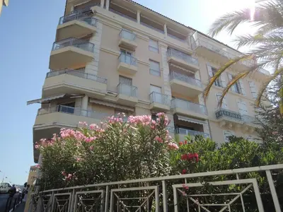 a building with pink flowers in front of it at Villa Rimbaud in Cannes