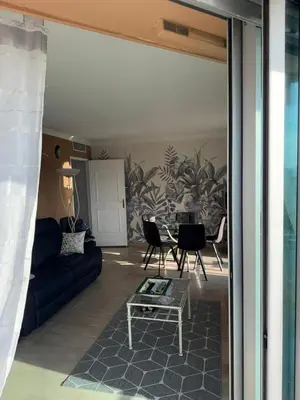 a living room with a couch and a table at Villa Rimbaud in Cannes