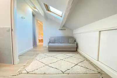 a living room with a couch and a rug at Modern & bright 4-room apartment in Cannes Banane in Cannes
