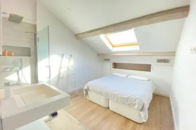 a bedroom with a bed and a sink and a mirror at Modern & bright 4-room apartment in Cannes Banane in Cannes