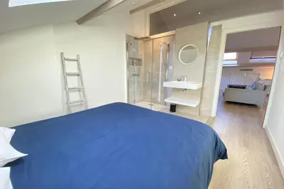 a bedroom with a blue bed and a sink at Modern & bright 4-room apartment in Cannes Banane in Cannes