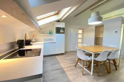 a kitchen and dining room with a table and chairs at Modern & bright 4-room apartment in Cannes Banane in Cannes