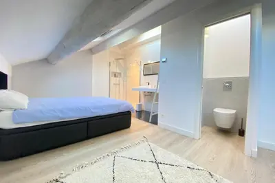 a bedroom with a bed and a bathroom at Modern & bright 4-room apartment in Cannes Banane in Cannes