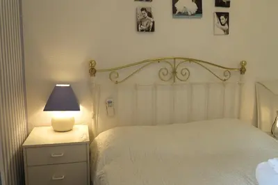 a bedroom with a bed with a lamp on a night stand at Viva Riviera - 5 Rue Commandant André in Cannes