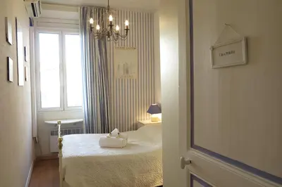 a small room with a bed and a window at Viva Riviera - 5 Rue Commandant André in Cannes