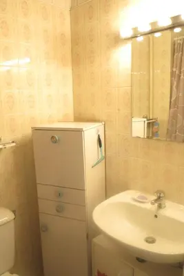 a bathroom with a sink and a toilet and a mirror at Viva Riviera - 5 Rue Commandant André in Cannes