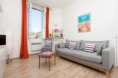 a living room with a couch and a table at Apartment29 in Cannes