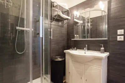 a bathroom with a shower and a sink and a mirror at Apartment29 in Cannes