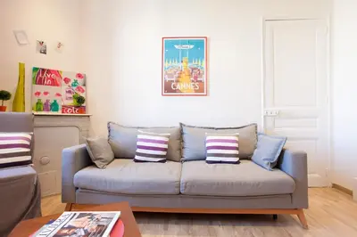 a living room with a couch with pillows at Apartment29 in Cannes