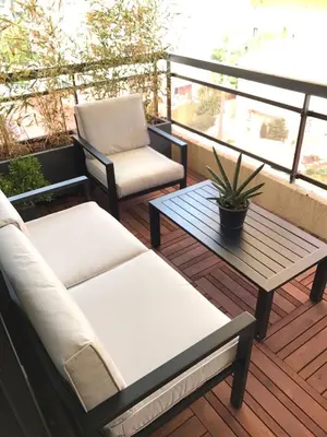a balcony with a couch and a table and a chair at Appartement Residence Athena in Cannes
