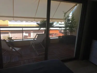 a room with a view of a balcony with a plant at Appartement Residence Athena in Cannes