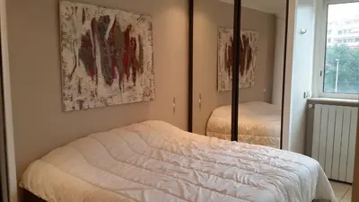 a bedroom with a bed and a mirror at Elegant Apart in City Centre of Cannes in Cannes
