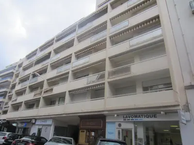 a large white building with cars parked in front of it at Elegant Apart in City Centre of Cannes in Cannes
