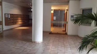 a hallway in a building with a column at Elegant Apart in City Centre of Cannes in Cannes