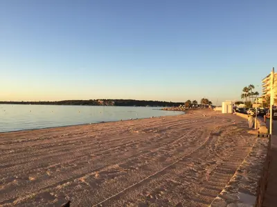 a sandy beach with a body of water at Immeuble le St Honorat in Cannes