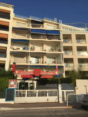 a large apartment building with a white fence in front of it at Immeuble le St Honorat in Cannes