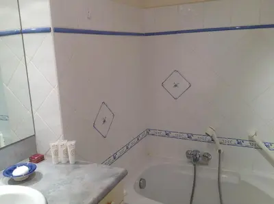a bathroom with a tub and a sink at Immeuble le St Honorat in Cannes