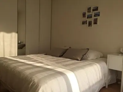 a bedroom with a large bed with white sheets at Immeuble le St Honorat in Cannes